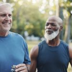 two middle aged men walking outdoors, representing men's health and early detection of cancer in men