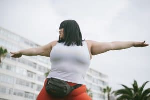 A woman with cropped black hair engages in fitness, one form of cancer prevention.