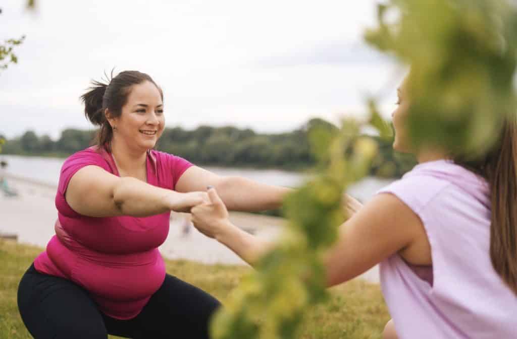 female fighting obesity with exercise