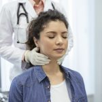 doctor checking female patient's lymph nodes for non-hodgkin lymphoma